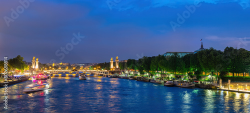 Paris France, panorama city skyline night at Seine River with Pont Alexandre III bridge and Grand Palais photo