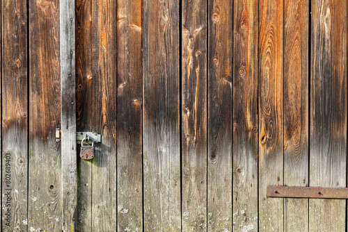 Aged wooden wall with iron lock background