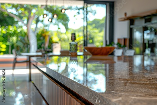 Close up photo of contemporary kitchen island with marble table top with kitchen blurry loose focal background - generative ai © Nia™