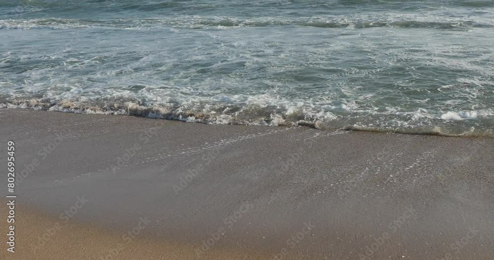 Waves on the beach. Water and sand.