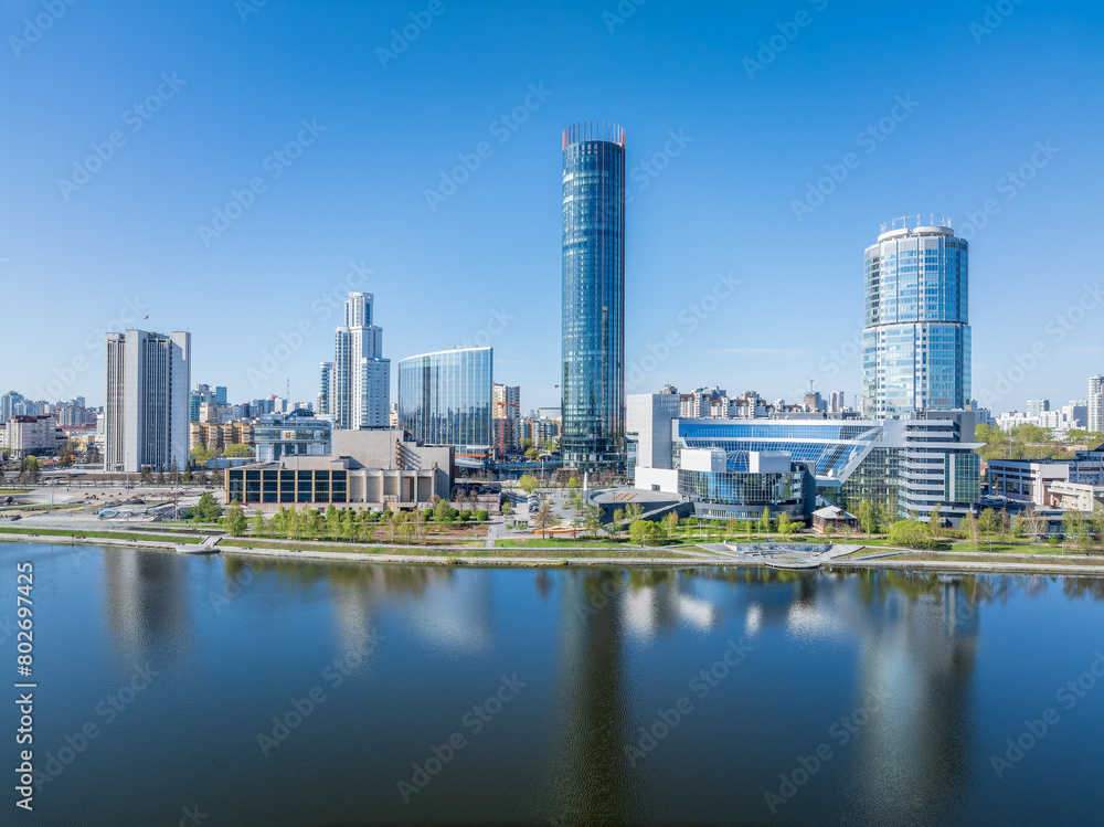 Obraz premium Yekaterinburg city with Buildings of Regional Government and Parliament, Dramatic Theatre, Iset Tower, Yeltsin Center, panoramic view at summer sunset.