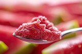 Close up of a spoonful of fresh watermelon slushie.
