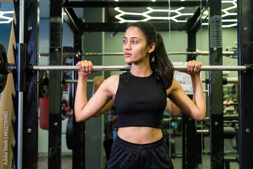 Fitness indian adult girl weight lifting barbell in gym. sports, Exercise, Workout, Training, muscle strength training health lifestyle. 