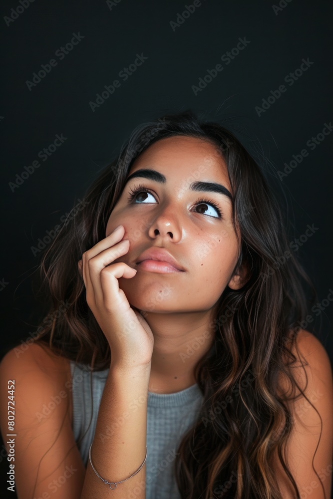 Thoughtful Young Woman Posing Against Dark Background Thoughtful Young Woman Posing Against Dark Background