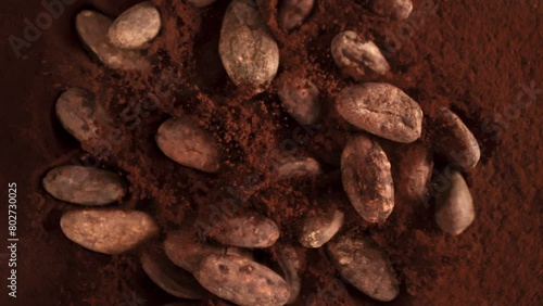 Super Slow Motion Shot of Chocolate Beans Followed by Camera Falling into Cocoa Powder at 1000fps.