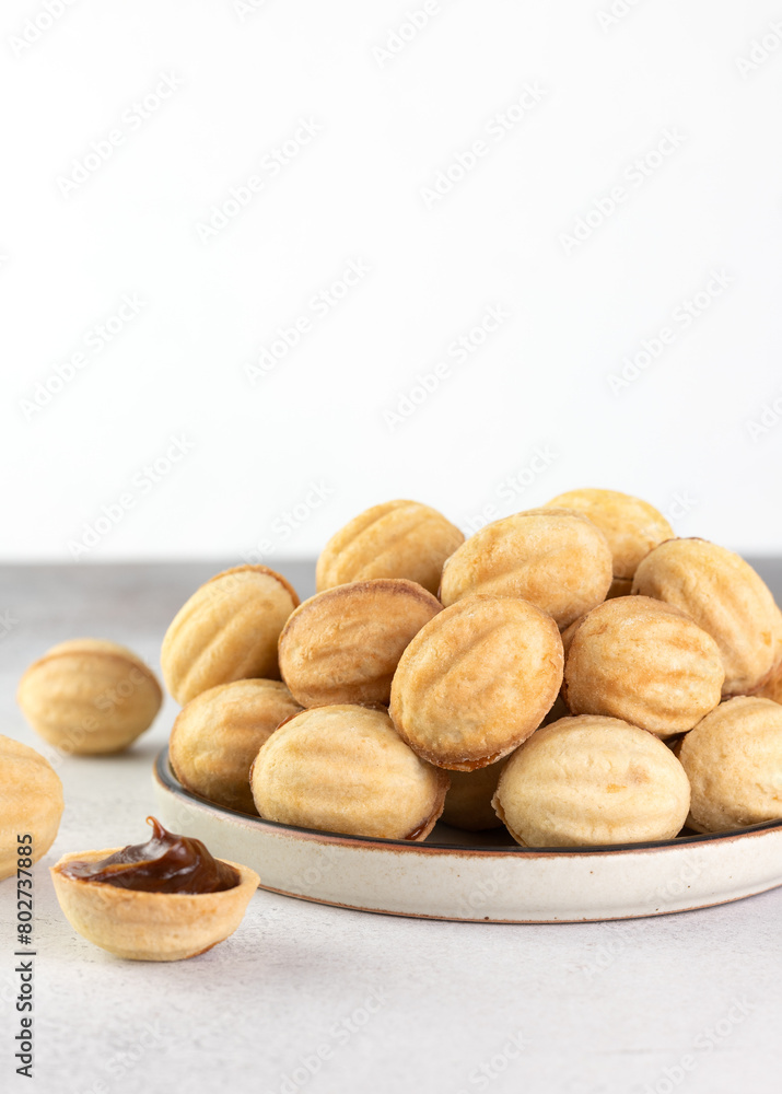 Russian cookies Nuts or Oreshki in shape of a walnut with boiled condensed milk. Russian cuisine, desserts. Copy space.