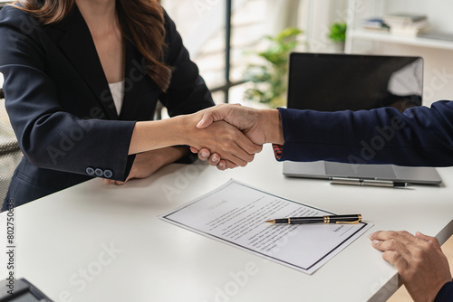 Job application concept: Manager and job applicant shake hands after a job interview. Job interviews to find people to join the company and talented people to work with