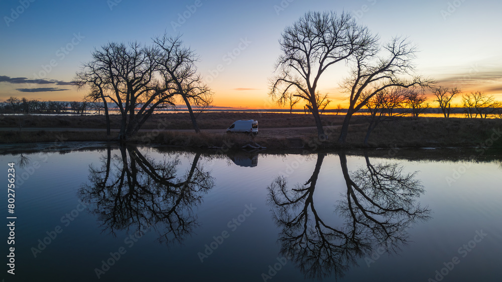 Sunrise Serenity: Van beside Calm Waters