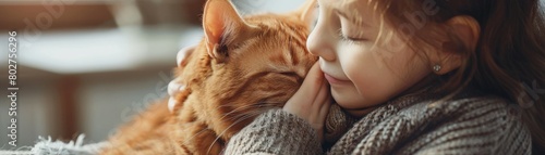Child gently petting an orange cat, fostering gentle interactions and the bond between kids and pets photo