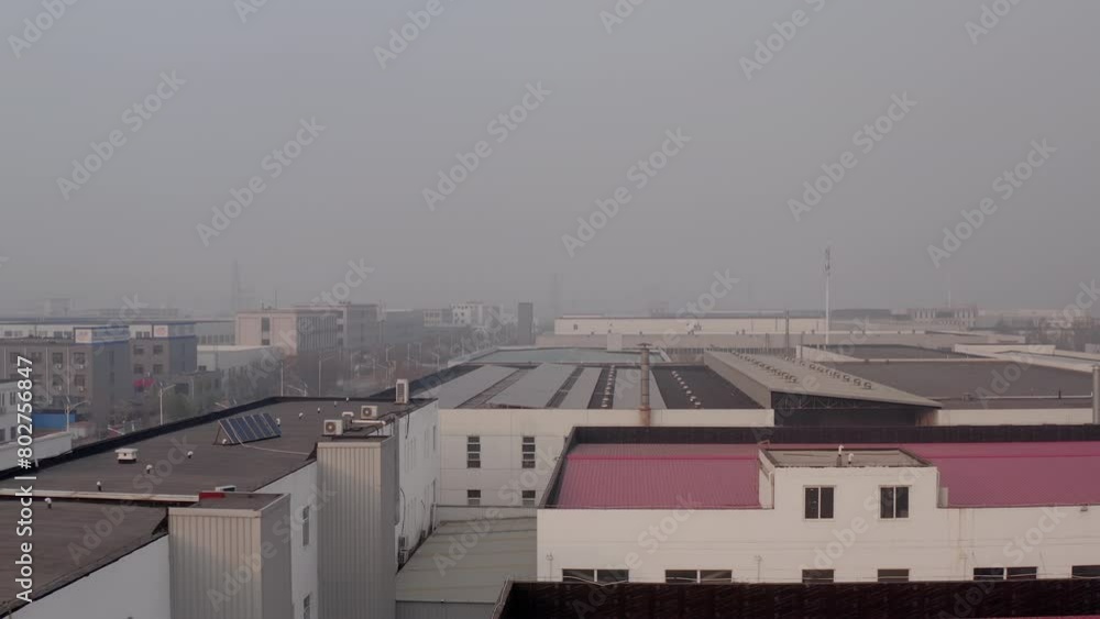 Industrial zone full of factories and warehouses in Tianjin, China. Solar panels on building roofs. Environmental regulations aimed at promoting sustainable development and minimising ecological harm. Industrial zone full of factories and warehouses in Tianjin, China. Solar panels on building roofs. Environmental regulations aimed at promoting sustainable development and minimising ecological harm.