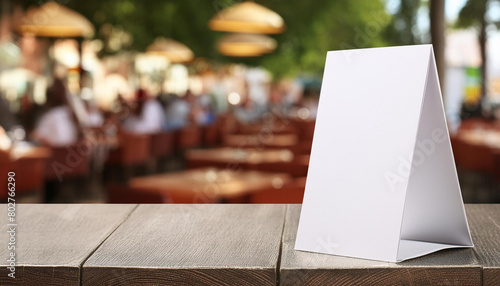 Three-Dimensional Blank Table Tent Mockup for Eatery Menu, blurred restaurant background