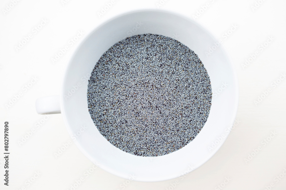 Blue poppy seeds birds eye view in white ceramic bowl with handle Blue poppy seeds birds eye view in white ceramic bowl with handle