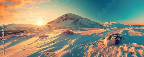 A beautiful winter landscape with a snow-capped mountain in the distance photo
