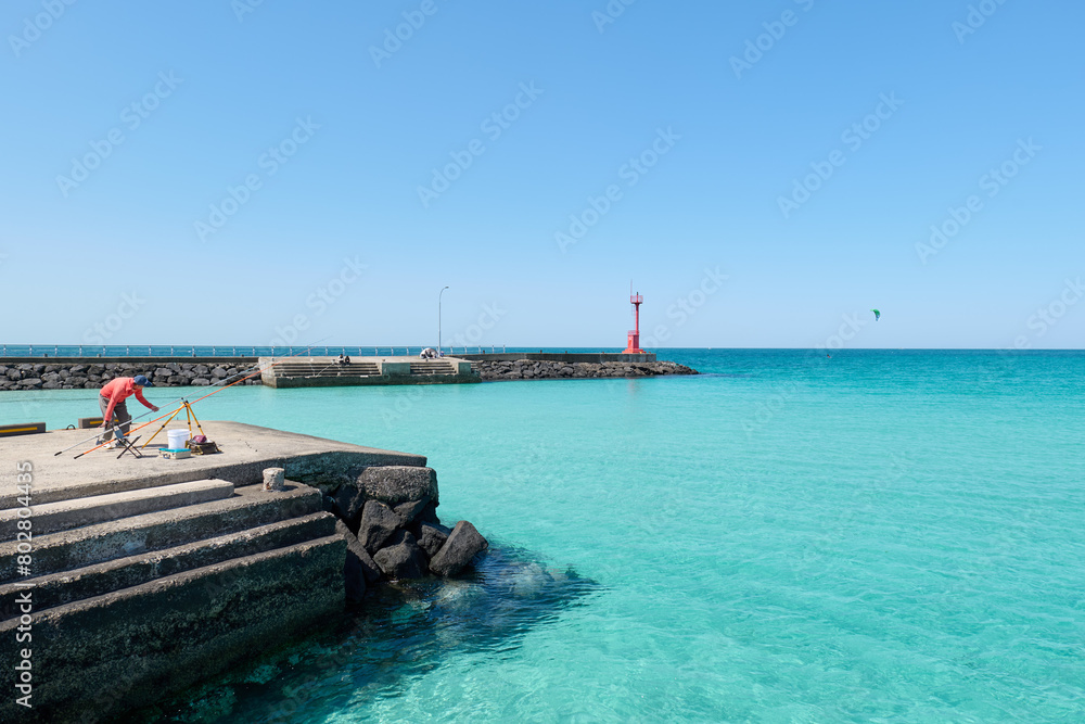 Clear and transparent sea and sky scenery. A man fishing. Jeju island. Clear and transparent sea and sky scenery. A man fishing. Jeju island.