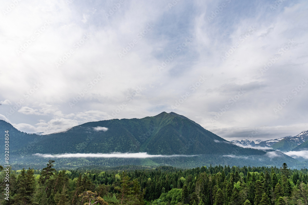 Obraz premium Beautiful panoramic view of the mountains. Arkhyz, Karachay-Cherkessia. Aerial beautiful summer landscape of the Caucasus mountains in the fog.