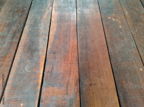 A photo of neatly arranged teak wood can be used as a background