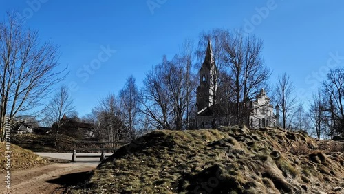 Cinevilla Studio garden walkaround, medieval church backyard, sunny day in Latvia photo