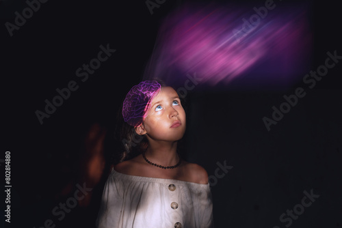 Schoolgirl thoughtfully seriously looking up, she imagines a rainbow, creative thinking, creativity, brainstorming, consciousness, connection with the higher self