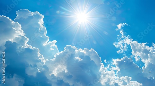 Bright blue sky with white clouds  perfect for a sunny summer day. The shining sun and fluffy clouds create a relaxing and peaceful atmosphere.