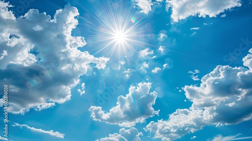 Bright blue sky with white clouds  perfect for a sunny summer day. The shining sun and fluffy clouds create a relaxing and peaceful atmosphere.