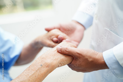 Asian doctor touching patient to support, consolation encourage and help support health care medical.