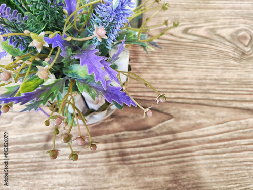 Colorful bouquet of gentle spring flowers placed on a rustic wooden table. Background  place for text  copy space