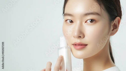 Beautiful woman holding a cosmetic cream jar and being cheerful