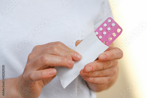 Pink Color Blister in Female Hands. Pack Emergency Contraceptive Pill for Women. Reduces Chance of Pregnancy. Estrogen and Progestin Oral Contraceptives.