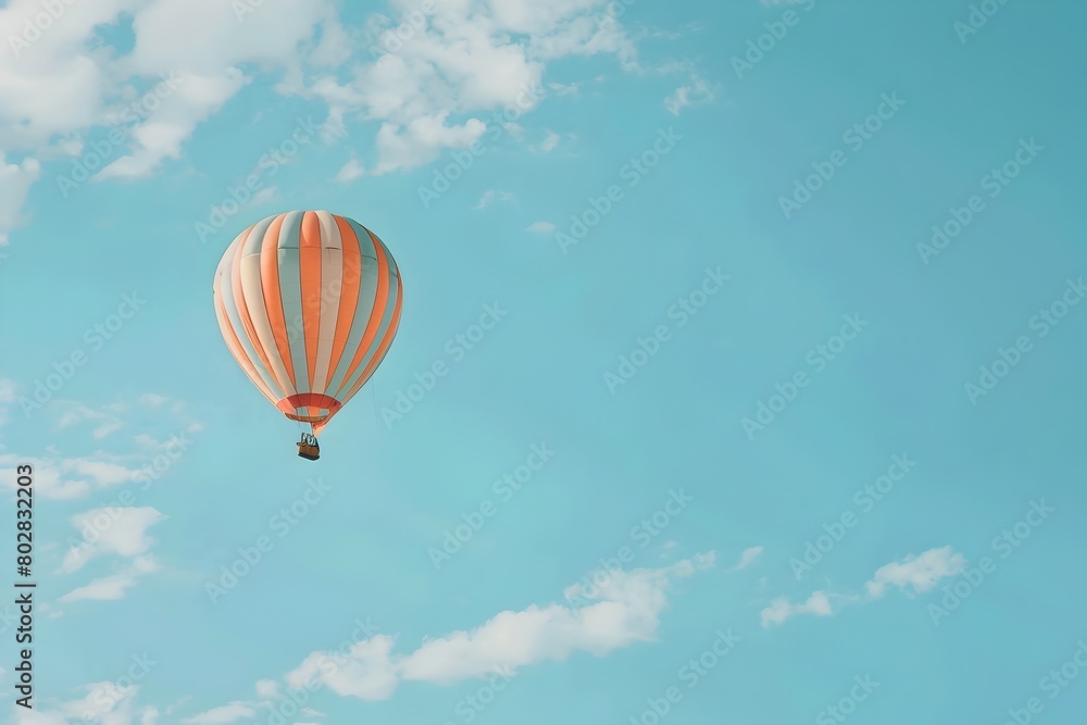 Naklejka premium Colorful Striped Hot Air Balloon Floating Across a Clear Blue Sky in a Whimsical Outdoor Adventure