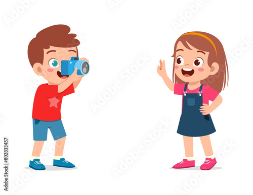 little kid holding camera and take photo of friend