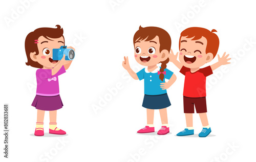 little kid holding camera and take photo of friend