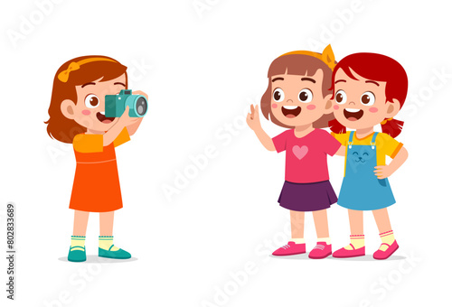 little kid holding camera and take photo of friend