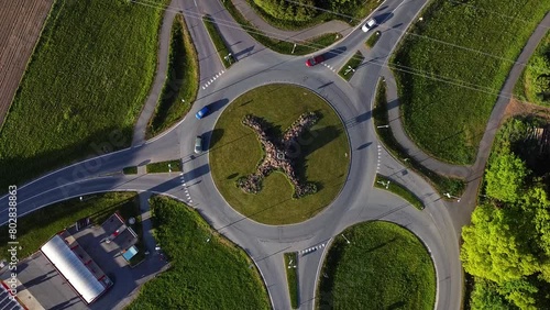 Several cars travel through 5 pointed round about. Static aerial view. photo