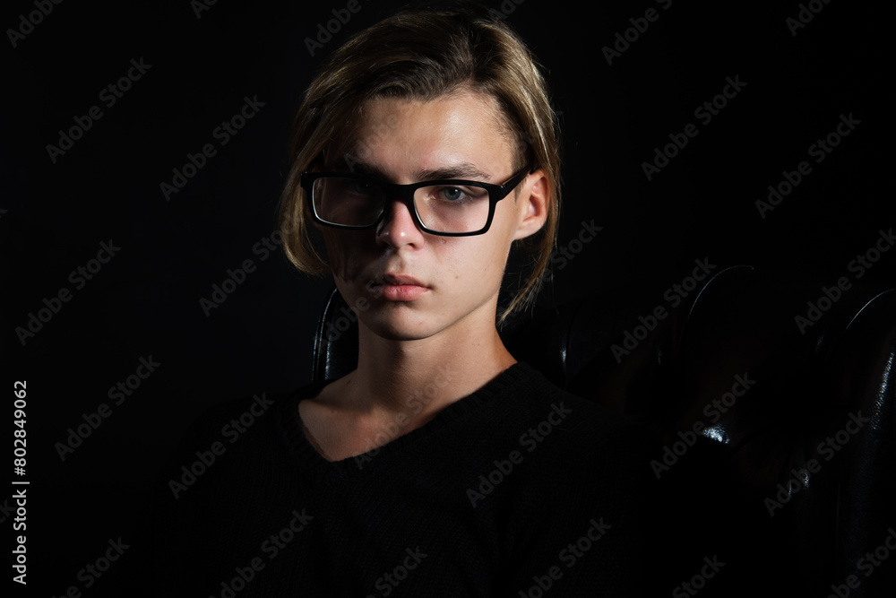 A young attractive guy is resting. Black background. A young attractive guy is resting. Black background.