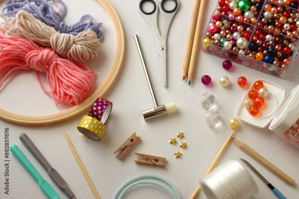 Various craft supplies on white background. Supplies for jewelry making, drawing and needlework. Selective focus.