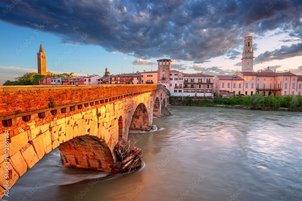 Verona, Italy. Cityscape image of beautiful Italian town Verona with the Stone Bridge over Adige River at sunset.