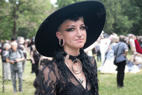 Young, smiling, female goth in black outfit on the annual Wave Gotik Treffen (Wave Gothic Meeting) in Leipzig, victorian picnic, Clara-Zetkin-Park photo