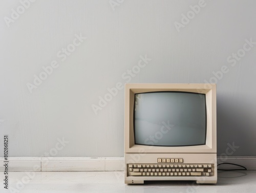 Old computer on a clean white desk minimalist design highlighting technology evolution