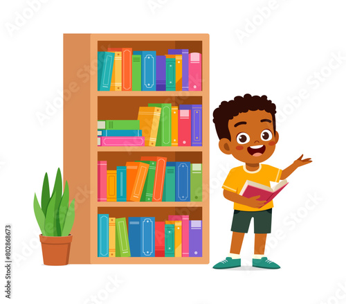 little kid read book in the library