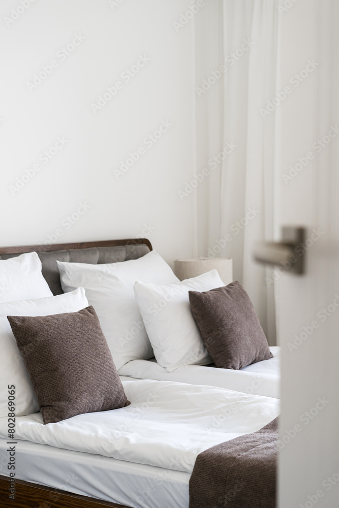 Open door in hotel room with comfortable double bed Open door in hotel room with comfortable double bed