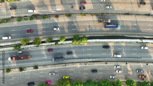 Aerial view by drone showcases the relentless stream of vehicles on the intercity motorway during peak hours, resembling a dynamic, high-speed metropolis in motion. Vehicle concept. Roads background. 