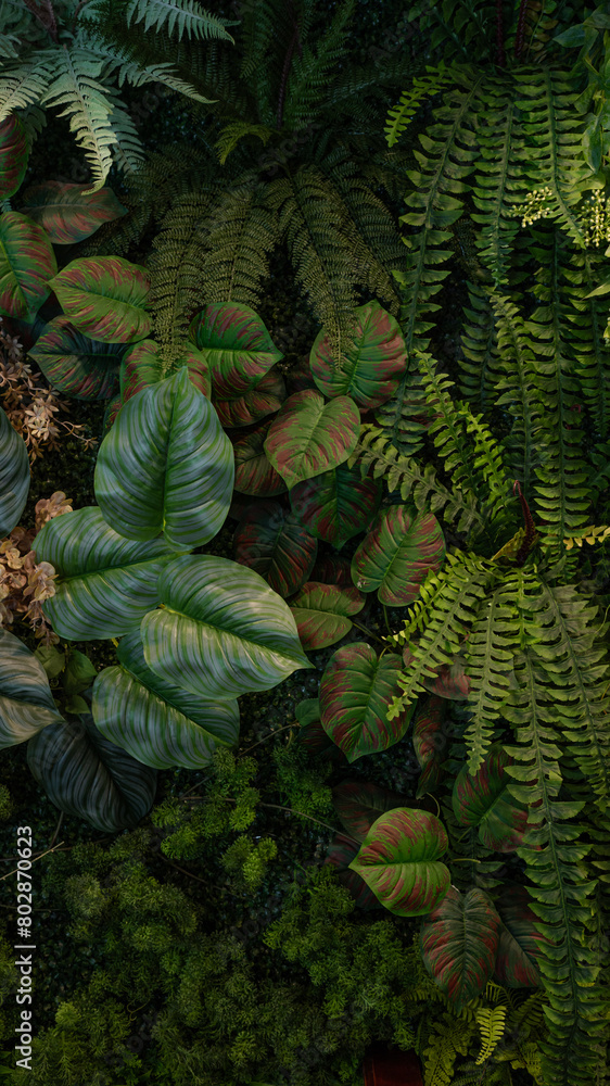 Fototapeta premium Tropical green leaves background, Nature Wall Lush Foliage Leaf Texture, Vertical image.