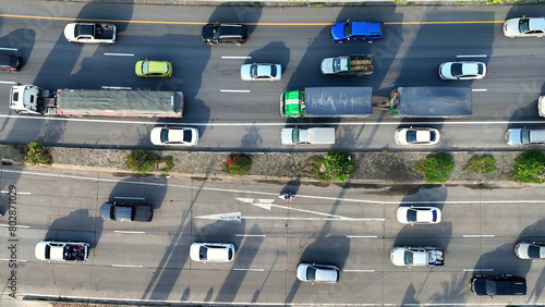 An intercity motorway, gridlocked with cars, stands still amidst a chaotic traffic jam. A drone captures the frustration from above. Traffic and vehicle concept. Road and cars background. Thailand.
 photo