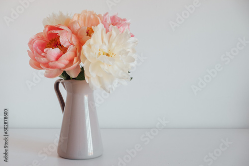 Fototapeta Naklejka Na Ścianę i Meble -  Beautiful fresh colorful peony flowers in full bloom in vase. Copy space for text. Floral still life with blooming peonies.