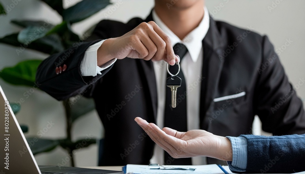Hands Real estate give keys to clients at their agency's offices. Hand focus
