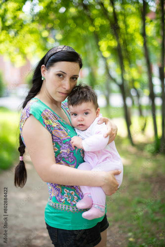 mother with baby, child in parent's arms, baby in pink overalls, baby laughing, happy baby, boy, girl mother with baby, child in parent's arms, baby in pink overalls, baby laughing, happy baby, boy, girl