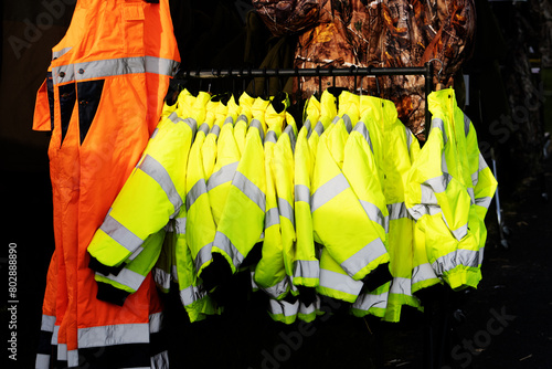 clothes rail of yellow hi-vis jackets and orange overalls