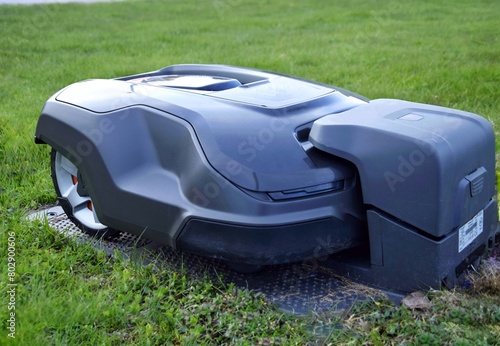 The robotic lawnmower is charging at the charging station