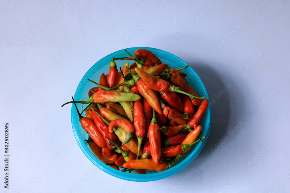 red cayenne pepper in a green bowl. spicy flavored vegetables red cayenne pepper in a green bowl. spicy flavored vegetables