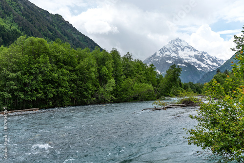 Beautiful landscape of a river with mountains in the background. Psysh River in the Caucasus Mountains.